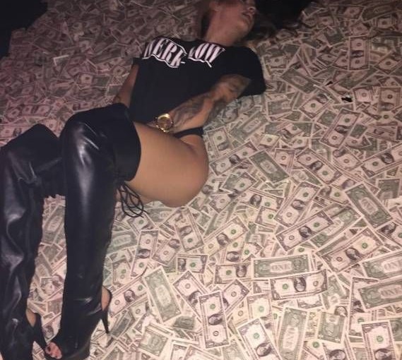 stripper laying on money
